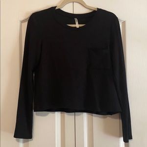 Black long sleeve crop top with pocket.